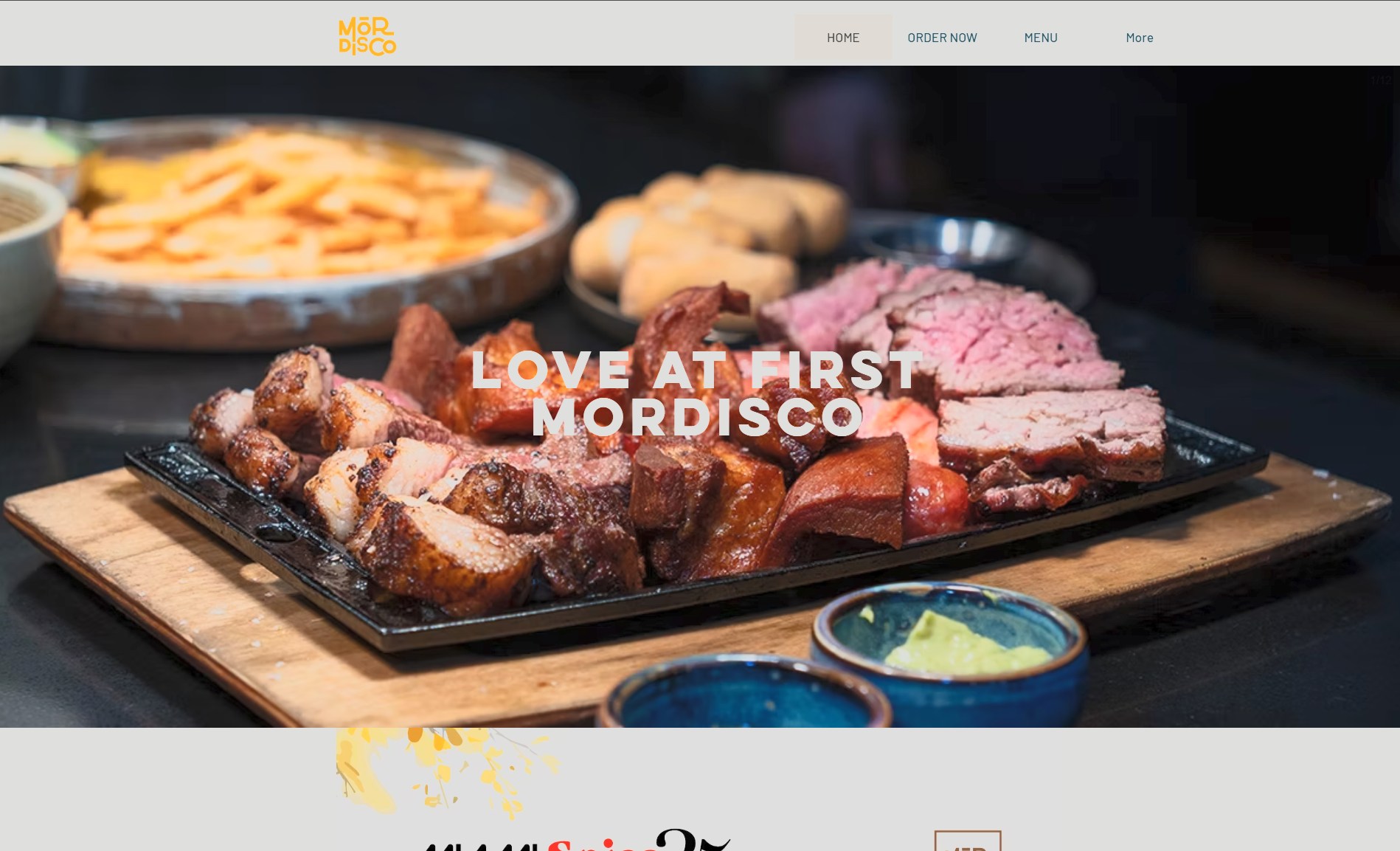 Full public Mordisco homepage opening with navigation, food photograph, and Love at First Mordisco headline