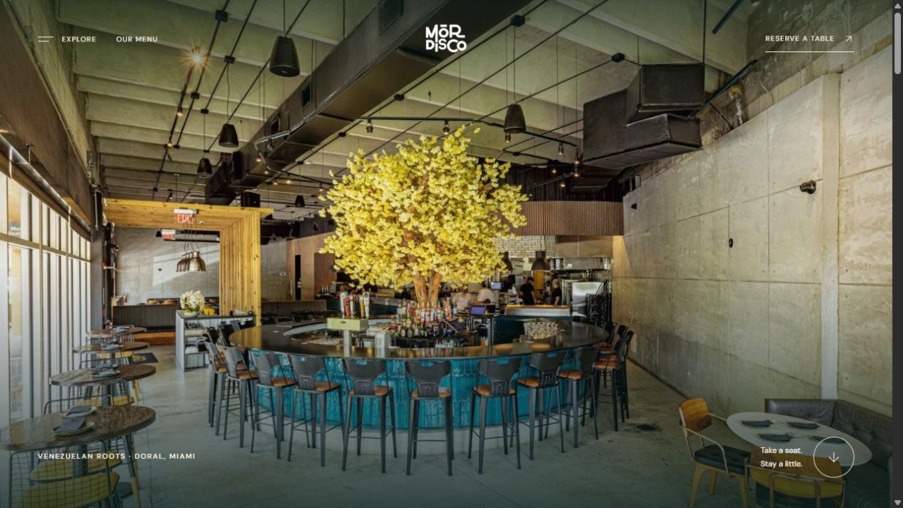 Mordisco concept hero with a sunlit dining room, yellow flowering tree, and teal circular bar