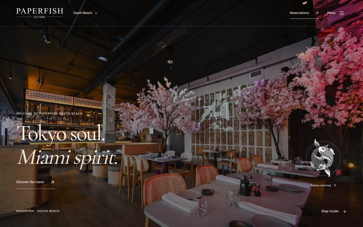 Paperfish South Beach concept homepage with its dining room, illuminated cherry blossoms, and menu link