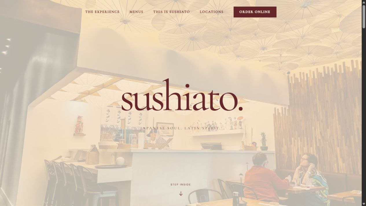 Sushiato concept opening inside a dining room beneath illuminated Japanese umbrellas